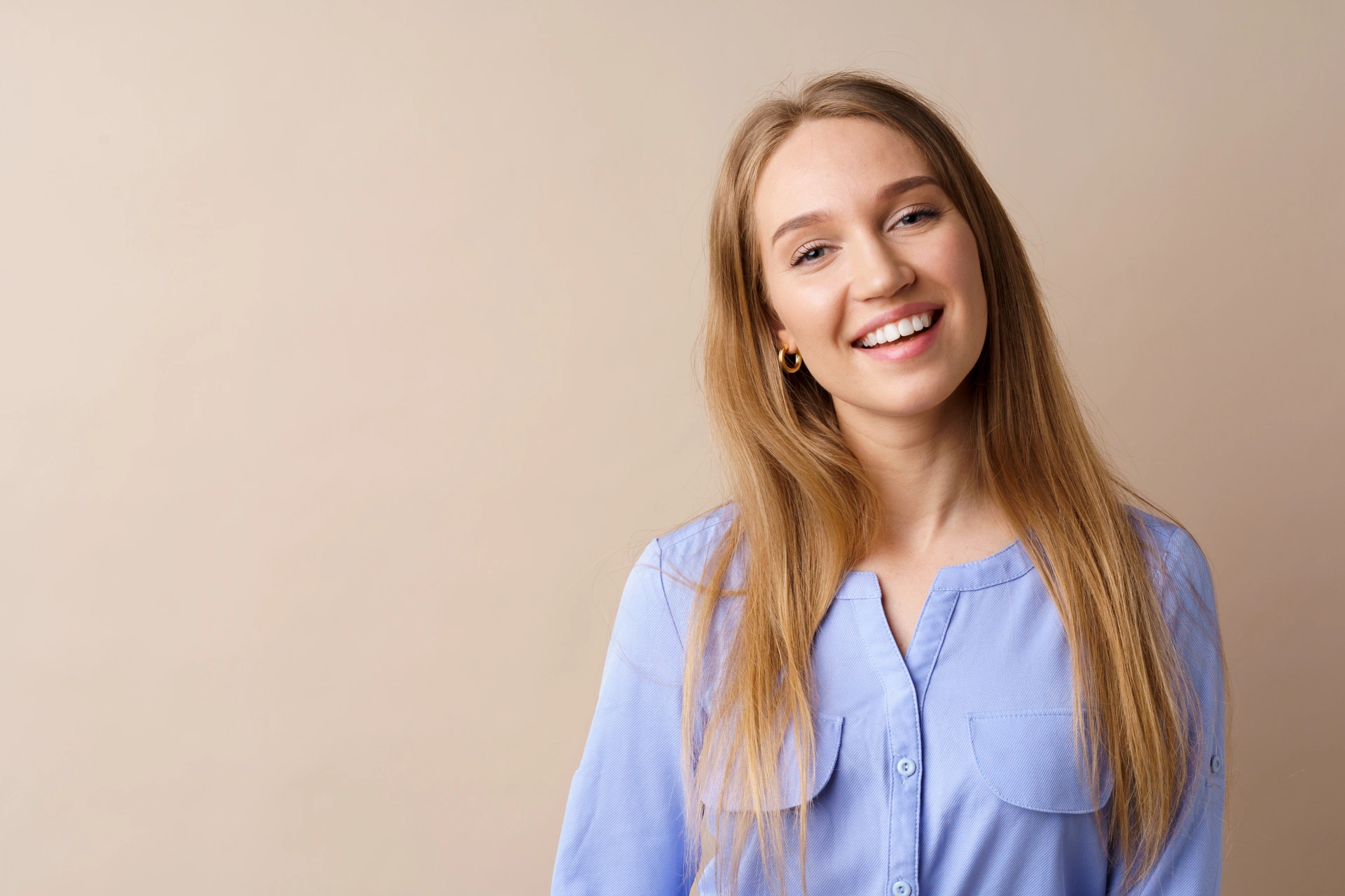 Smiling patient considering cosmetic dentistry options like veneers and bonding